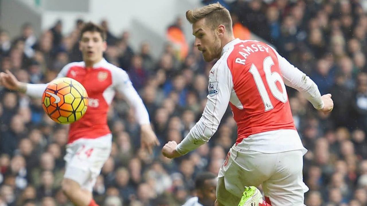 Aaron Ramsey watches his flick go into the net. 