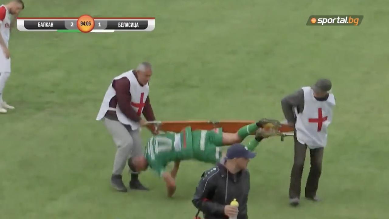 Soccer player falls off stretcher