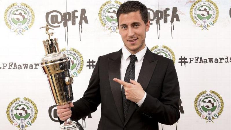 Eden hazard holding and pointing to the PFA Player of the Year award. 