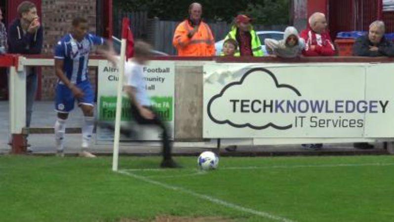 Boy runs on field, takes corner.