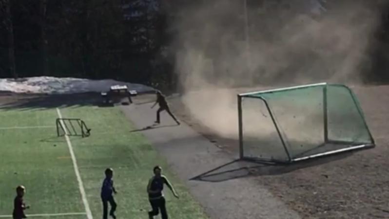 A dust devil carries away a soccer goal in Lillehammer, Norway - and sends kids running