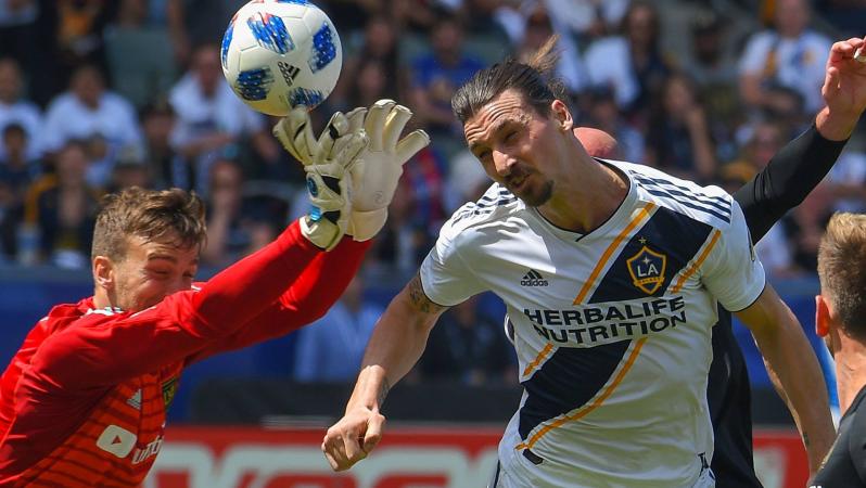 Zlatan heads the ball past LAFC goalkeeper Tyler Miller in the striker's MLS debut