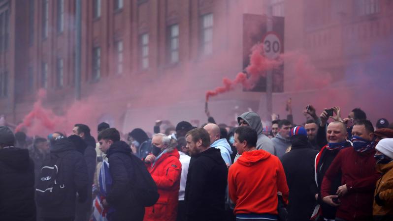 Rangers fans flouted coronavirus lockdown restrictions to gather outside Ibrox before and after their team's 3-0 win over St Mirren to move within a point of the Scottish Premiership title on Saturday.  Goals by Ryan Kent, Alfredo Morelos and Ianis Hagi continued Rangers' 100% home record with a 16th win and they will be champions if Celtic fail to beat Dundee United on Sunday.  Rangers have not won the title since 2011, since when they spiralled into financial turmoil and were demoted to Scotland's bottom 