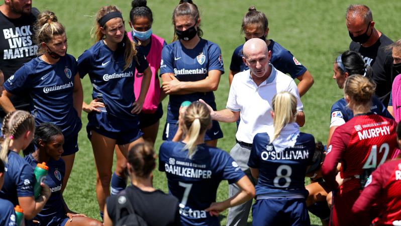Paul Riley head coach of North Carolina Courage talks with the team