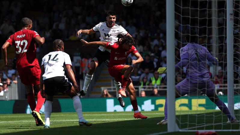 Aleksandar Mitrović jumps over Liverpool's Trent Alexander-Arnold to score Fulham's opening goal 