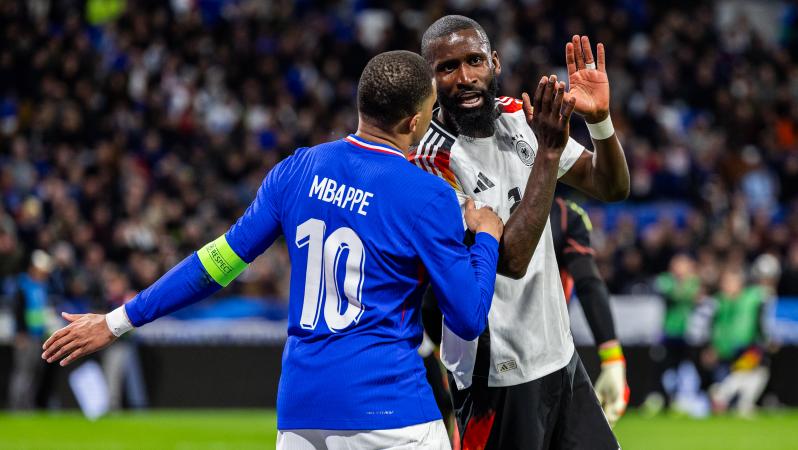 Antonio Rüdiger with Kylian Mbappé