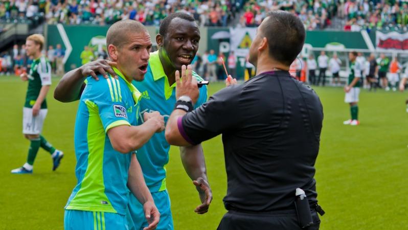 O.Alonso #6 and J.K.Hurtado #34 of the Seattle Sounders appeal to referee during a Seattle Sounders vs. Portland Timbers match