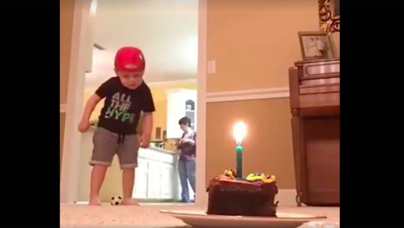 Kid extinguishes candle with soccer ball
