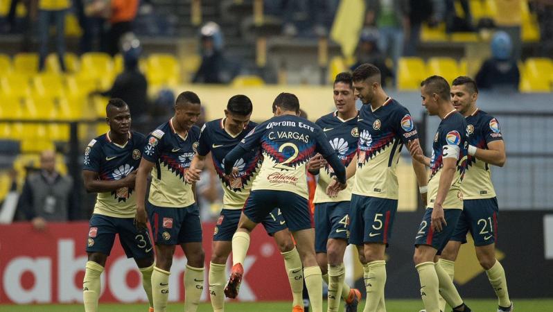 A happy Club America team huddles up after a goal