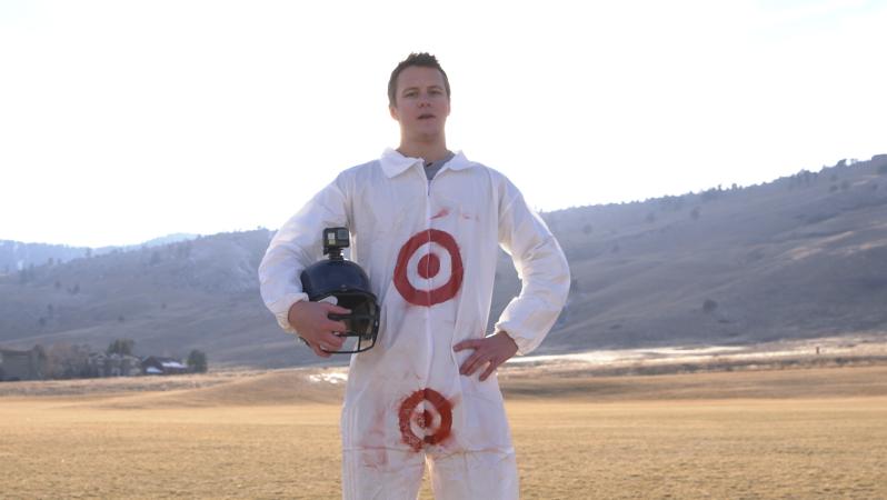 Jack the intern stands holding his helmet ready for action as Target Man