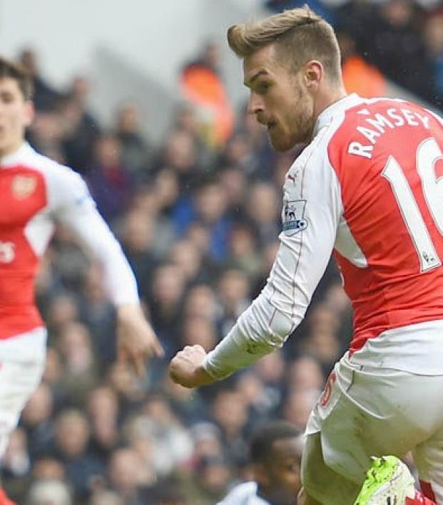 Aaron Ramsey watches his flick go into the net. 