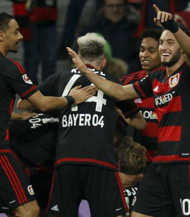 Calhanoglu celebrates with his teammates. 