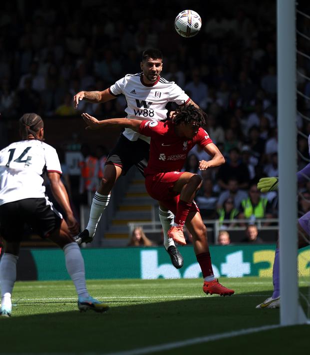 Aleksandar Mitrović jumps over Liverpool's Trent Alexander-Arnold to score Fulham's opening goal 