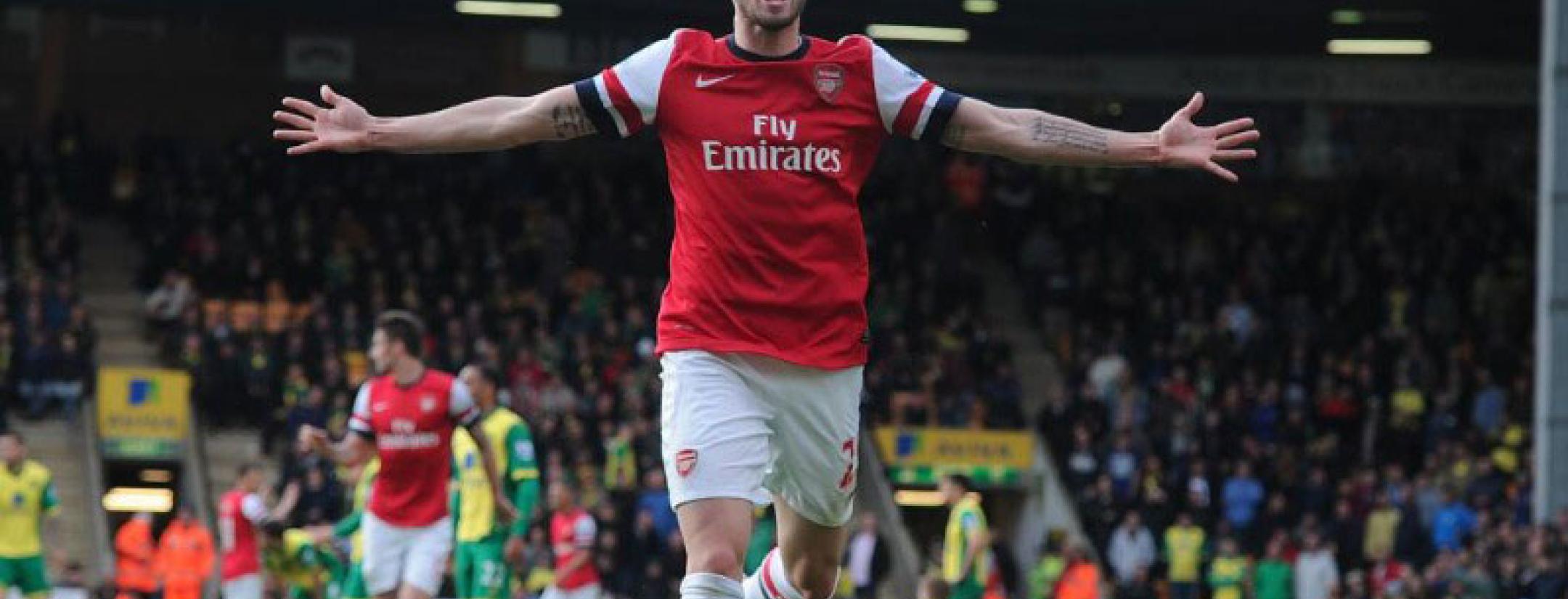 Carl Jenkinson celebrates, arms wide open, after his first goal for the Gunners
