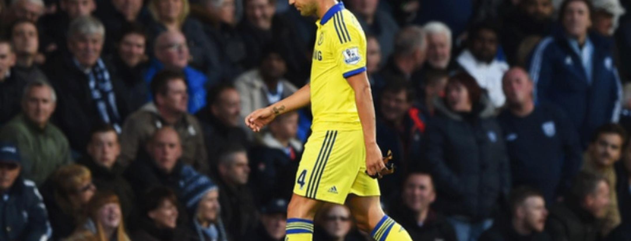 Fabregas walks off the pitch after an early red card