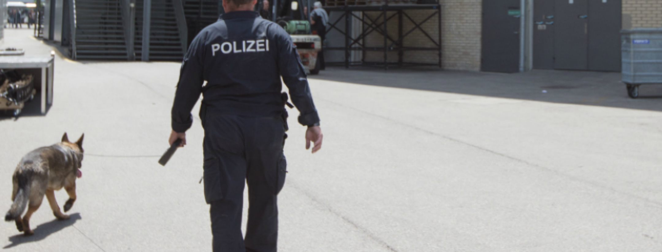 A policeman and his dog are pictured. 