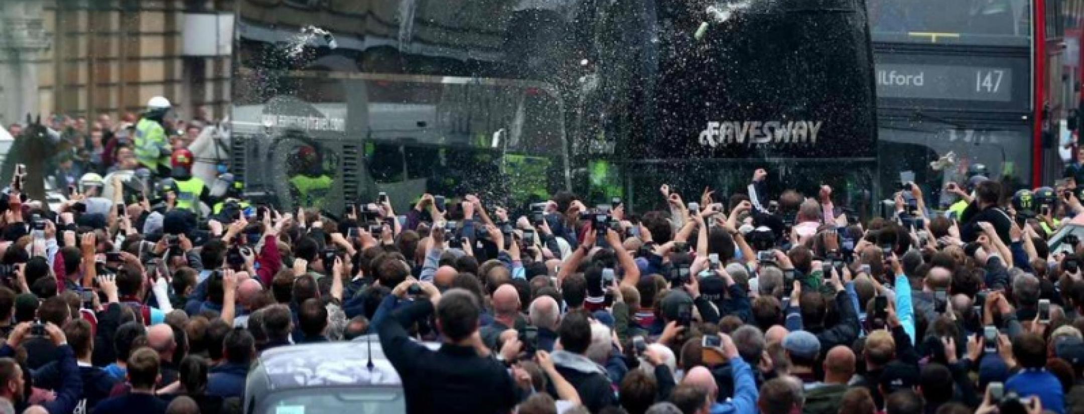 West Ham fans throw beer and debris at Man U Bus