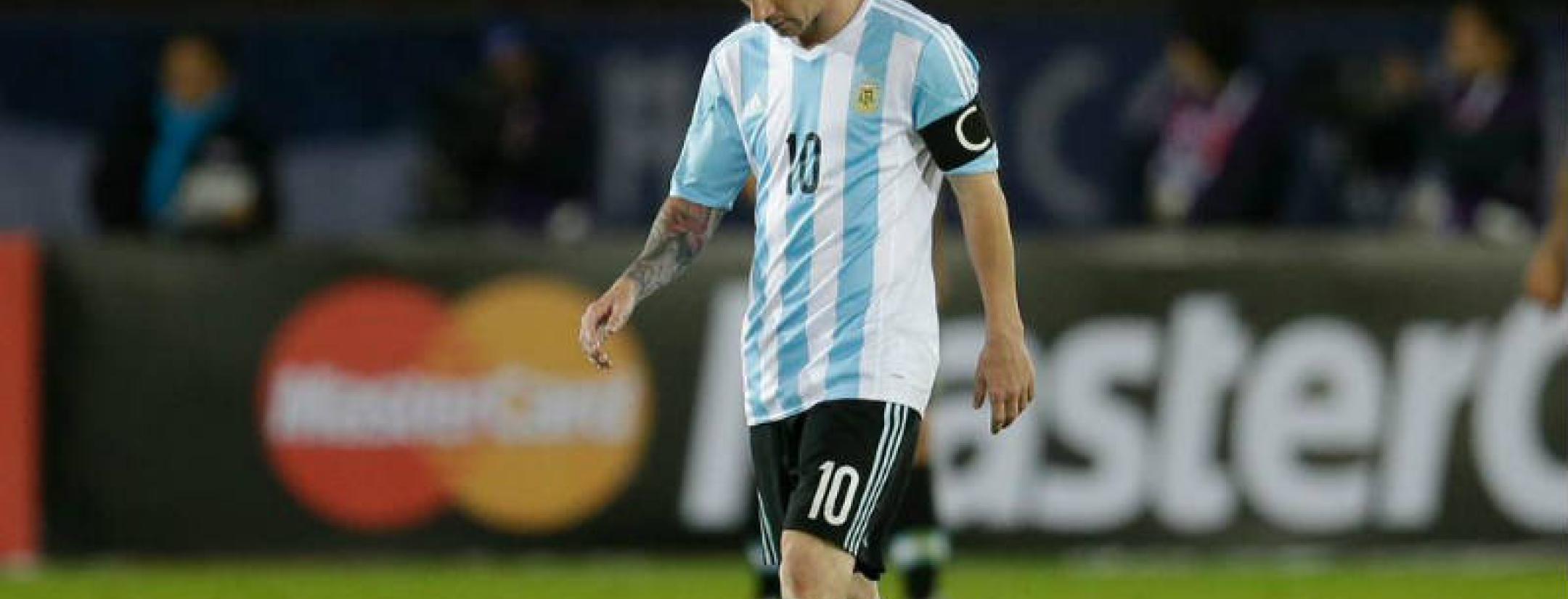 Lionel Messi looking upset in his Argentina kit.