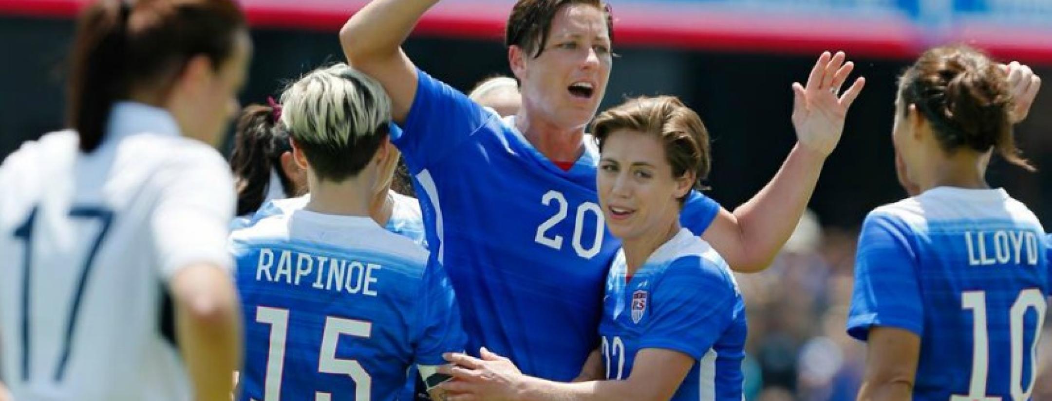Abby Wambach celebrates magnanimously with her teammates Carly Lloyd and Megan Rapinoe. 