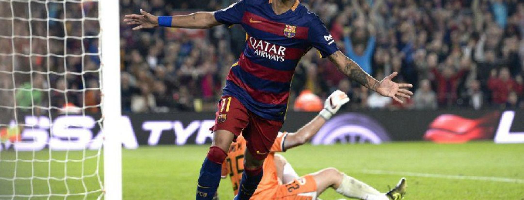 Neymar celebrating scoring a goal with his arms oustretched. 