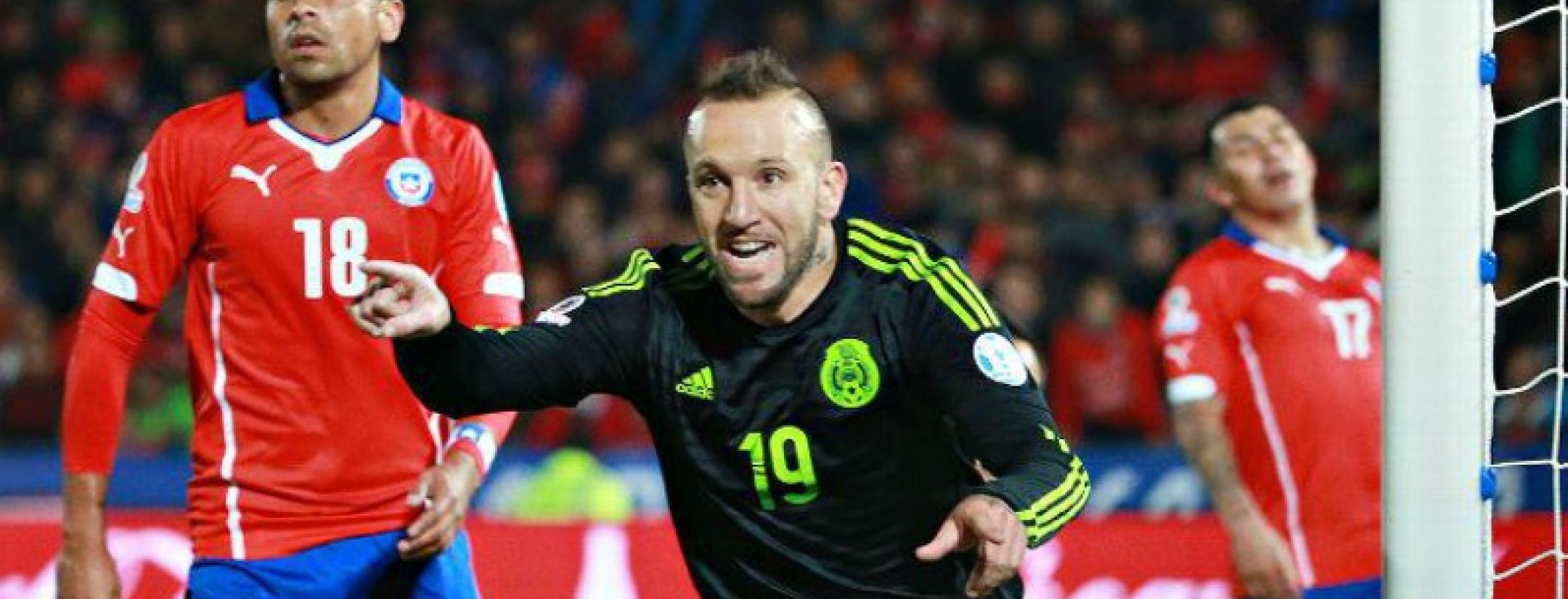 Matias Vuoso is shown pointing towards something out of the frame and running towards the camera as he celebrates a goal.