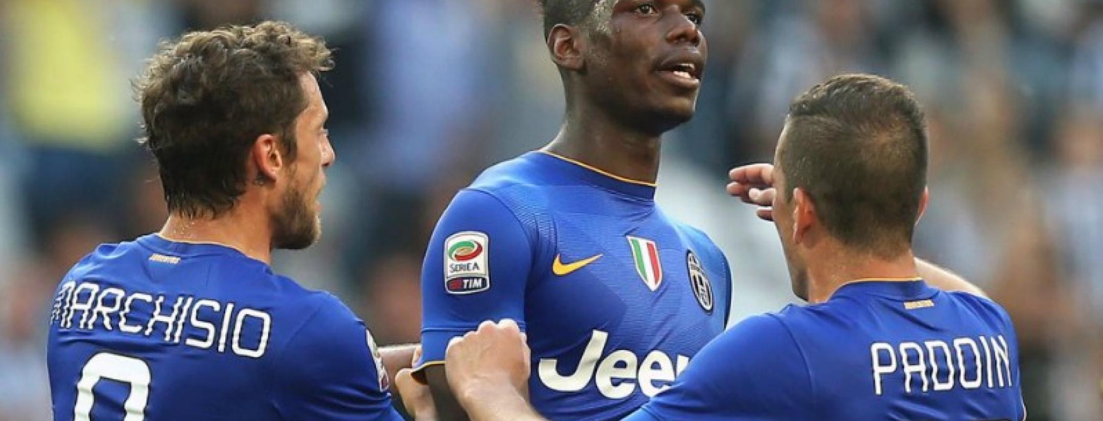 Paul Pogba is congratulated by teammates Marchisio and Paddin as he looks on calmly. 