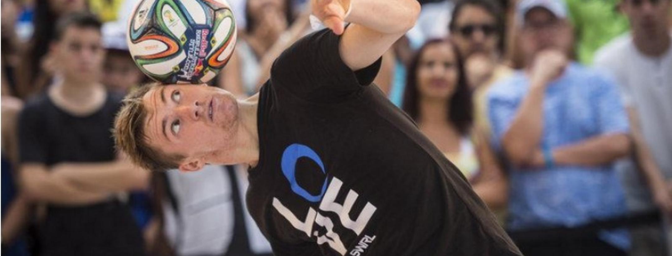 Andrew Henderson stalls a soccer ball on his head 