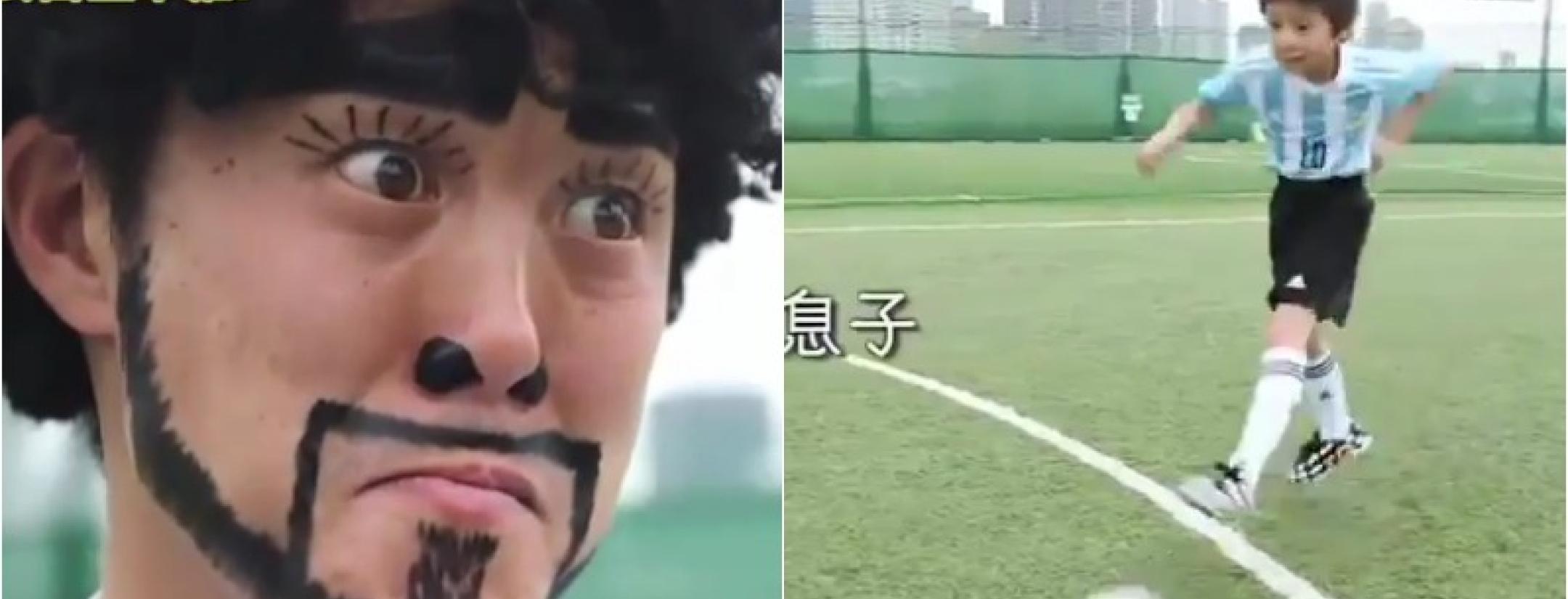 A man in make-up and a wig attempts to look like Diego Maradoa, and looks ridiculous in doing so. 