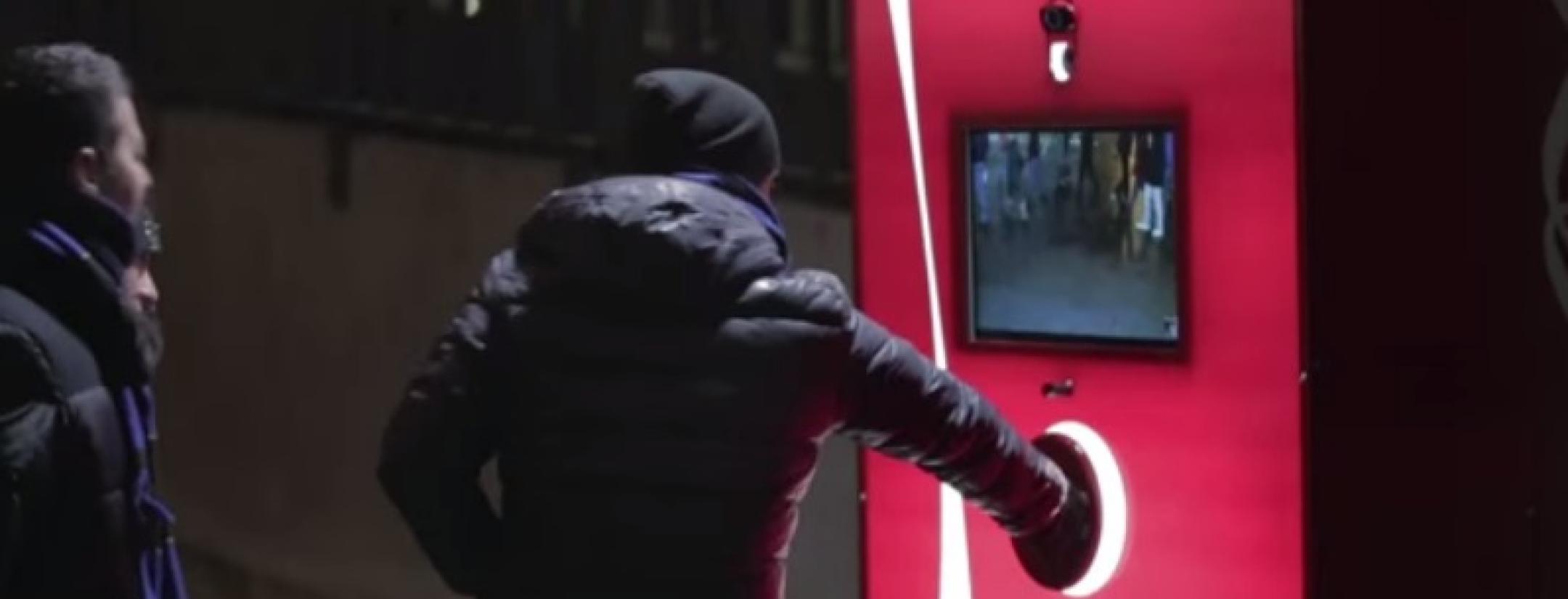 A fan pushes the "share" button on Coca-Cola's fair play machine during an Inter versus Milan match