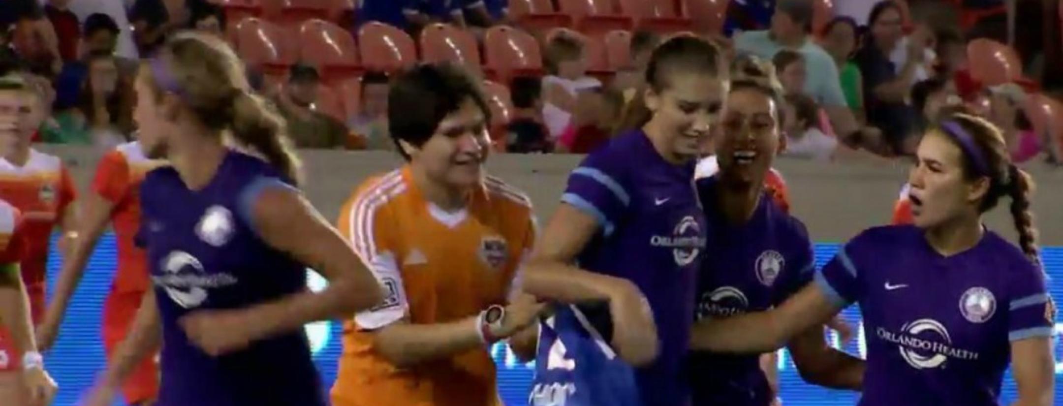 A pitch invader goes after Alex Morgan.