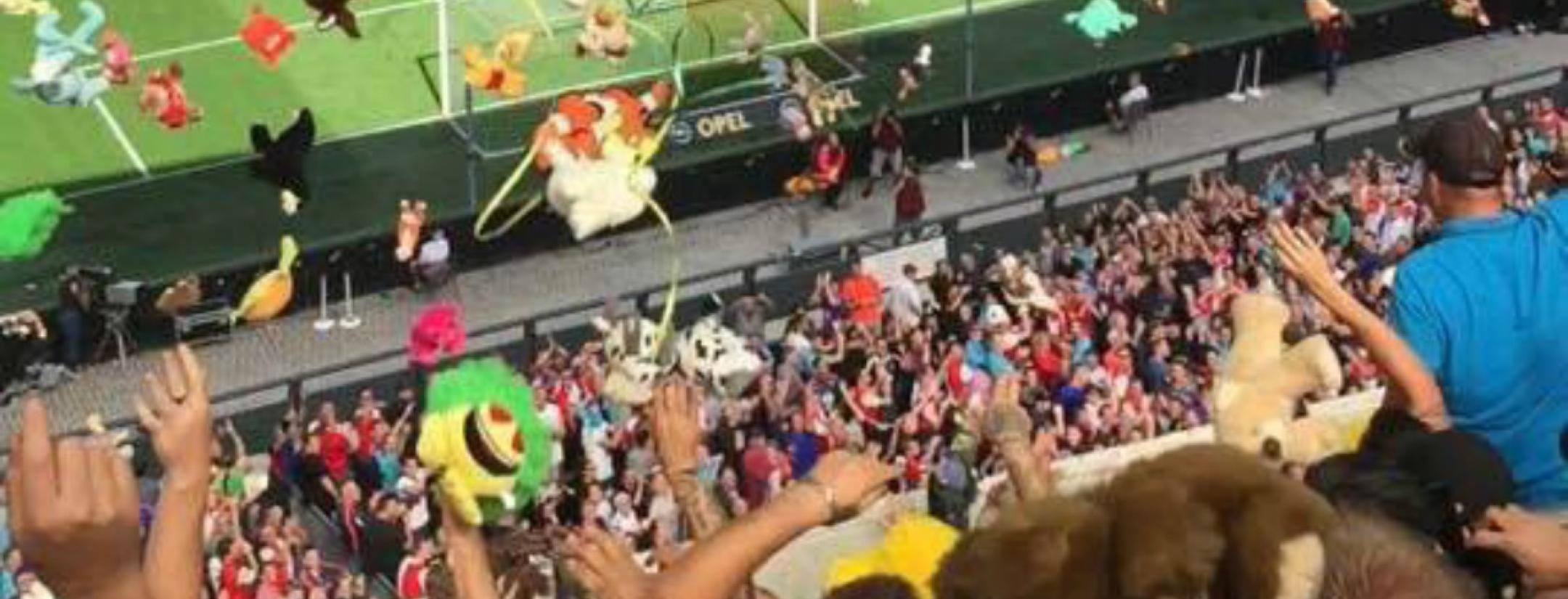 ADO Den Haag fans throw stuffed animals.