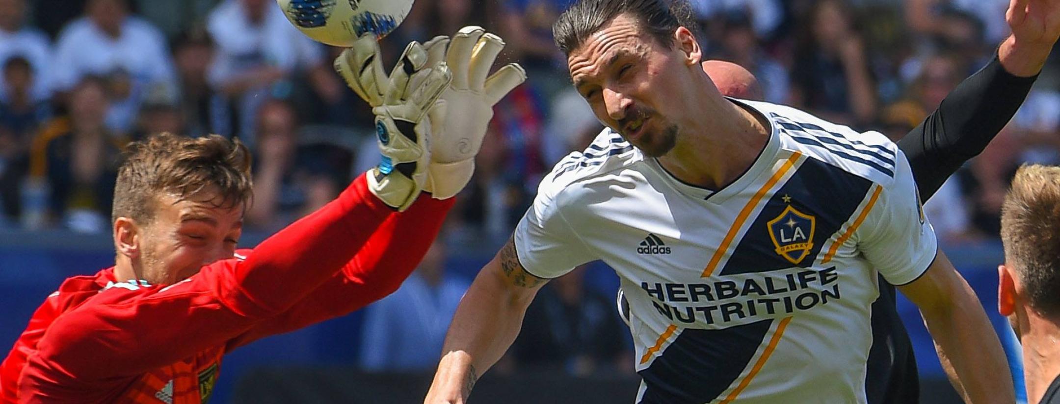 Zlatan heads the ball past LAFC goalkeeper Tyler Miller in the striker's MLS debut