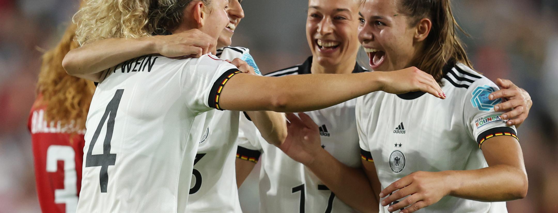 Germany players celebrate their third goal against Denmark