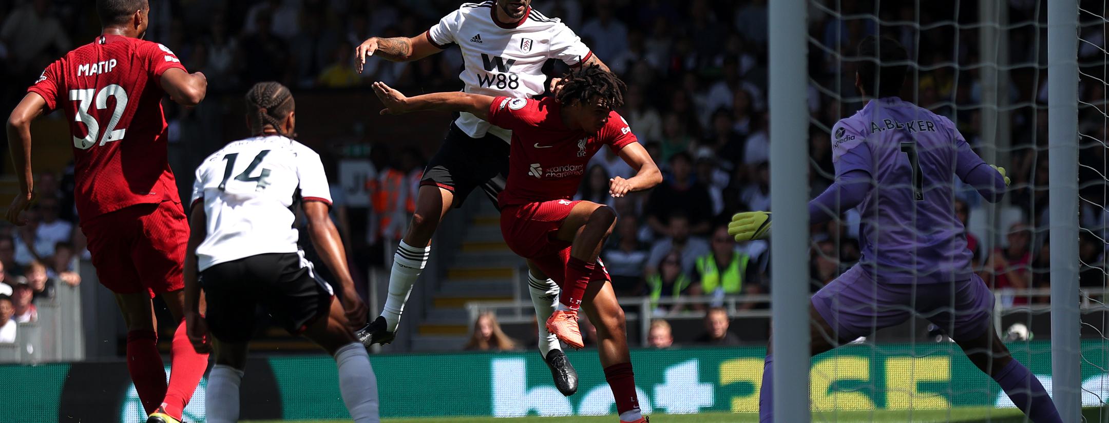 Aleksandar Mitrović jumps over Liverpool's Trent Alexander-Arnold to score Fulham's opening goal 