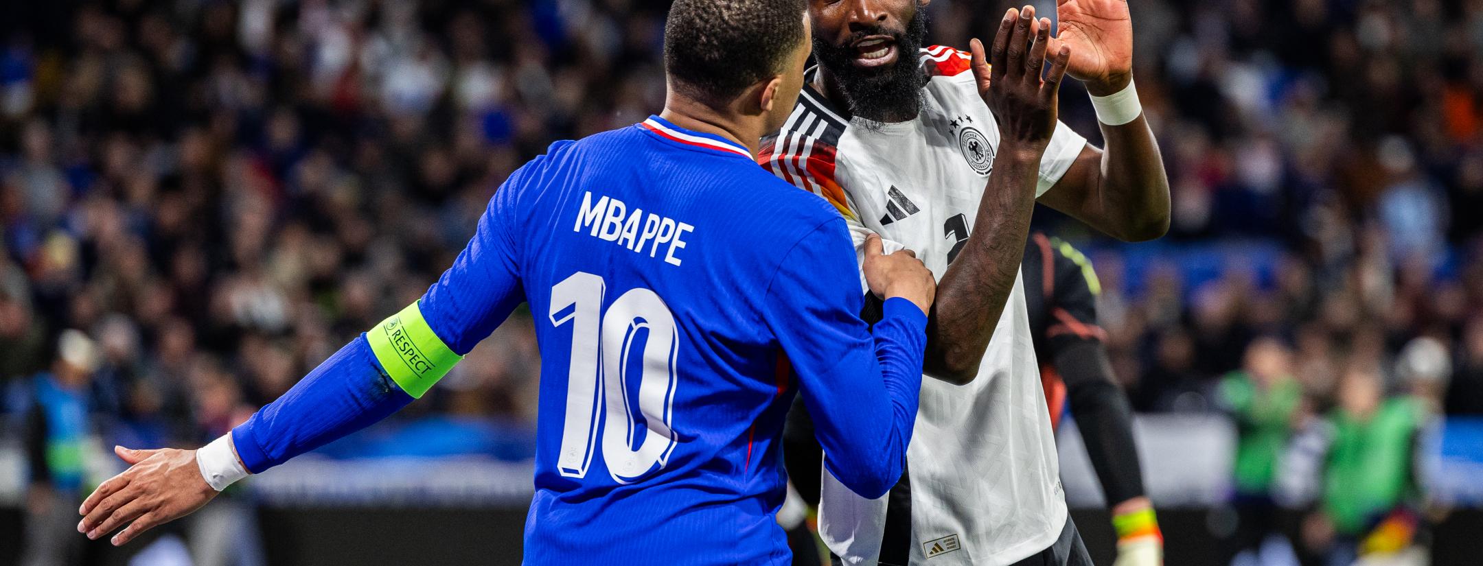 Antonio Rüdiger with Kylian Mbappé