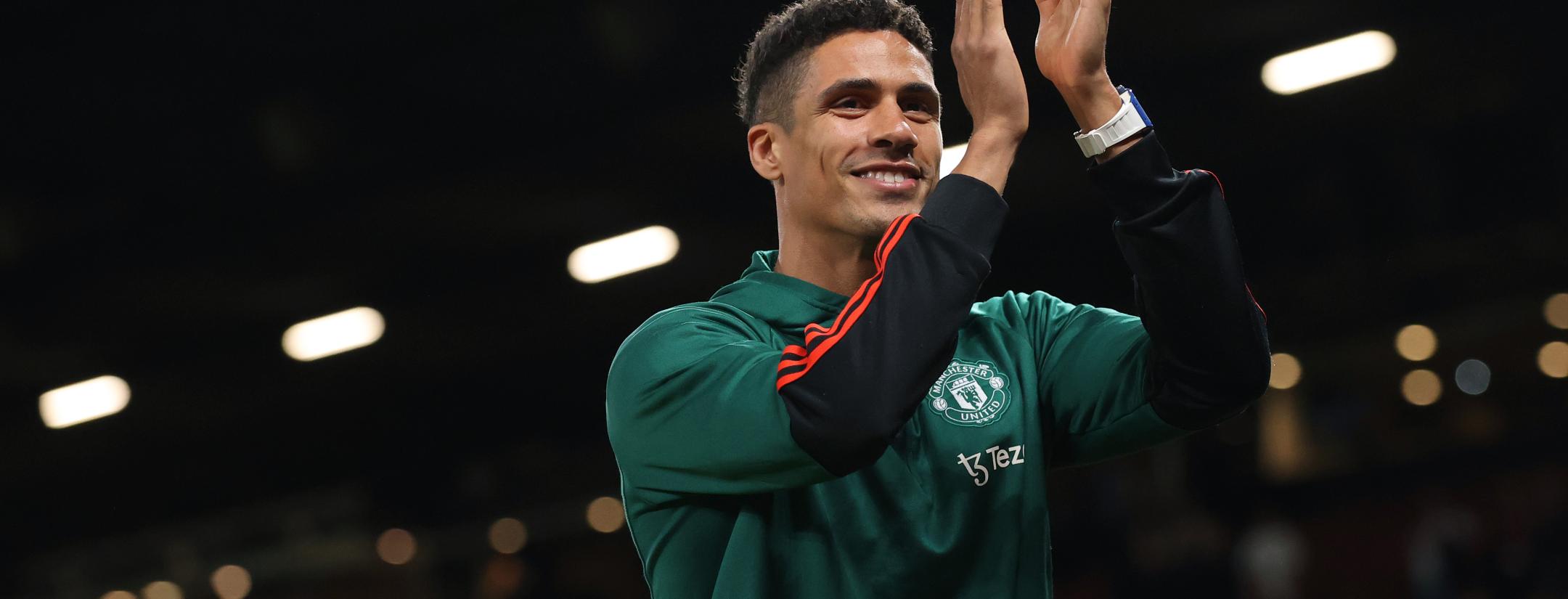 Raphaël Varane applauds fans at Old Trafford