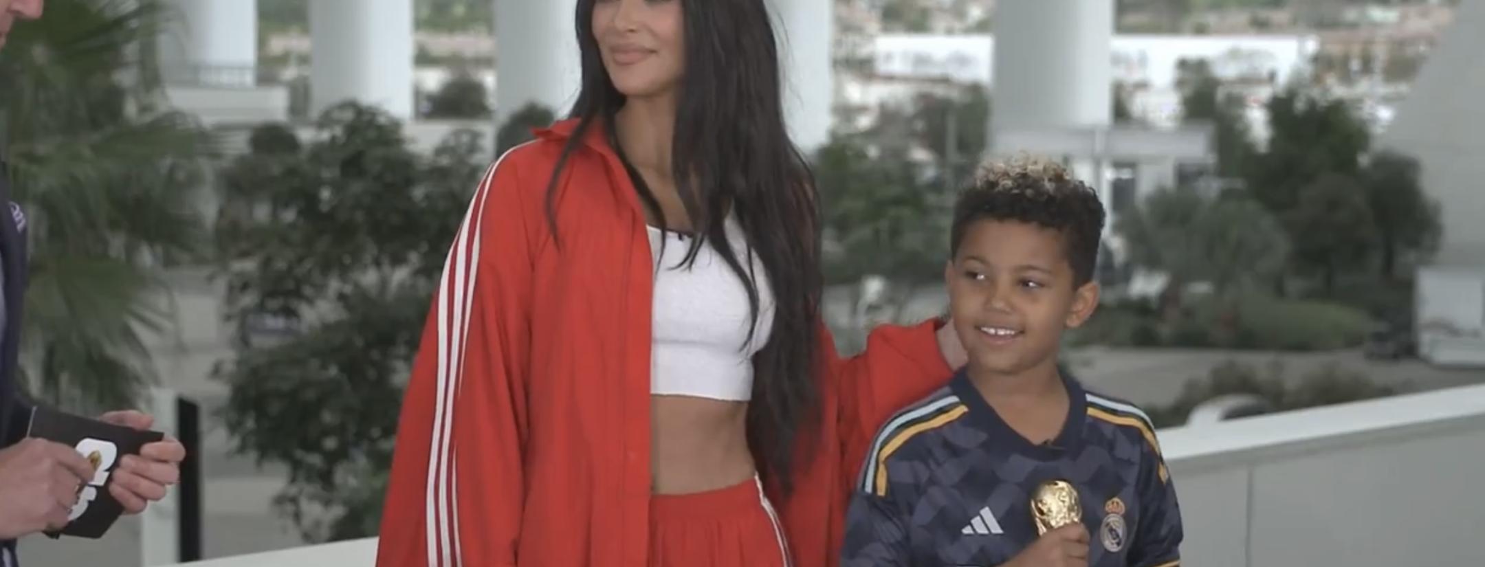 Kim Kardashian standing next to her son Saint West