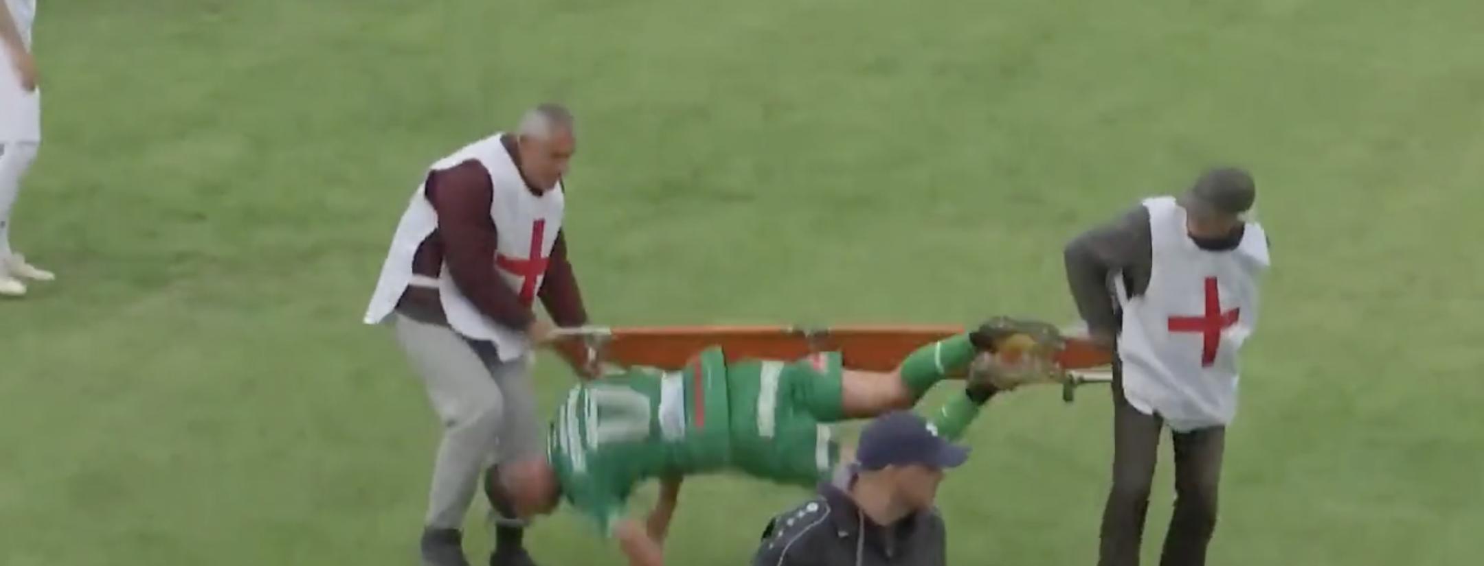 Soccer player falls off stretcher