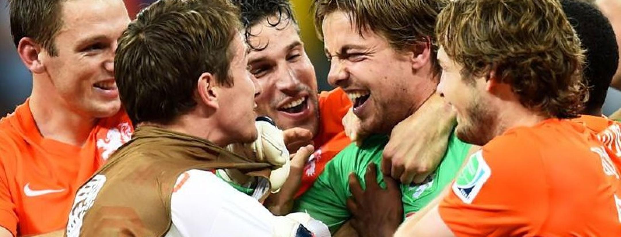 Dutch players swarm backup keeper Tim Krul after his game-winning save