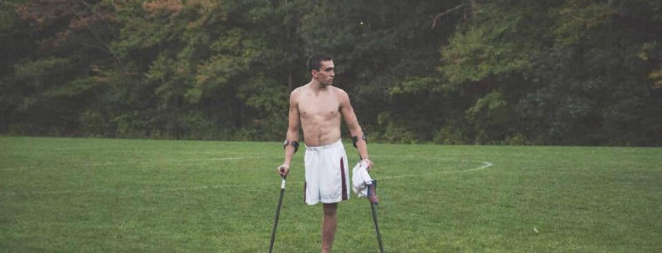 One-legged footballer Nico Calabria poses on the pitch