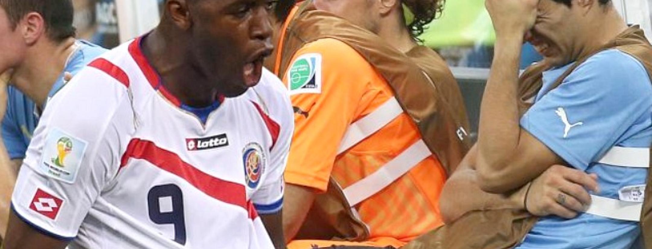 Joel Campbell of Costa Rica celebrates as Suarez cringes on the bench