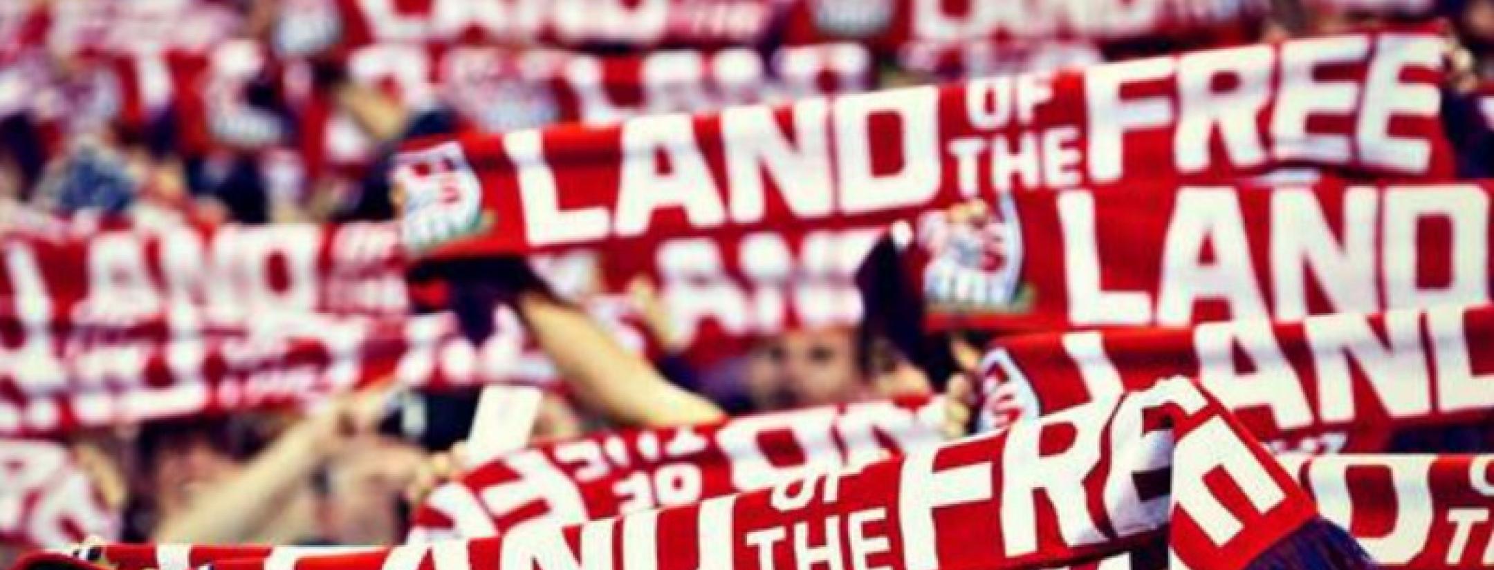American Outlaws raising "Land of the Free" scarves