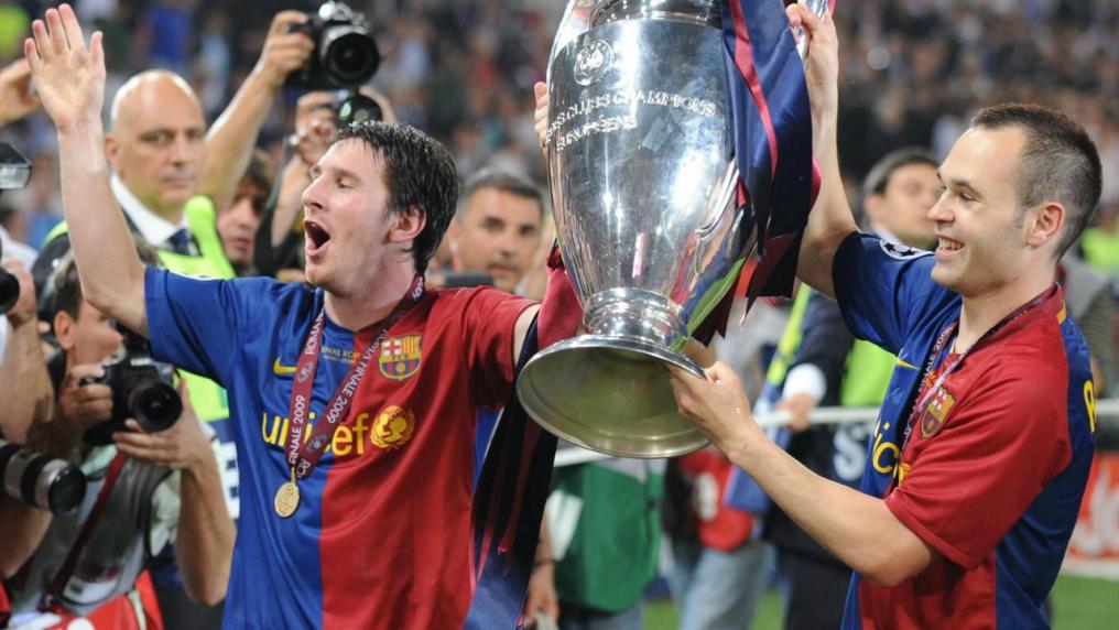 Messi Photos - Messi and Andres Iniesta hold up the 2009 Champions League trophy