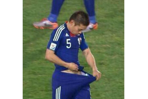 footballer checks his underwear mid game