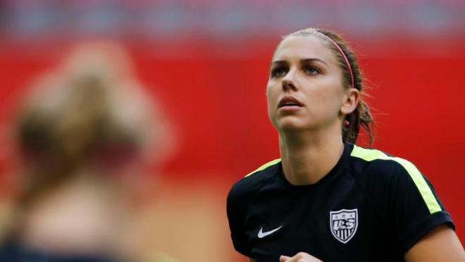 Alex Morgan is shown stoically looking up to the sky 