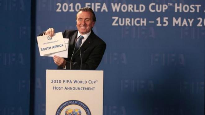 Tim Roth as Sepp Blatter is shown announcing the award of the 2010 World Cup to South Africa. 