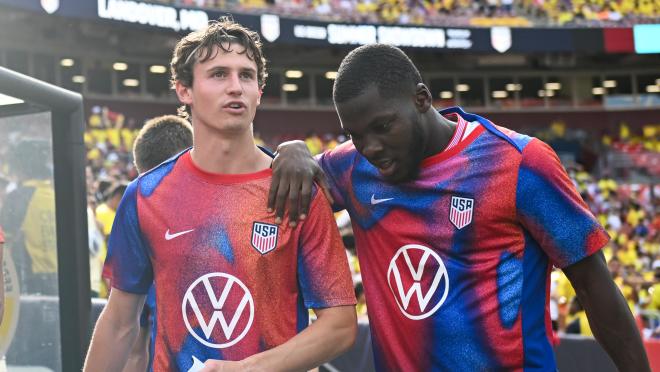 Brenden Aaronson #11 and Yunus Musah #6 of the United States enter the field before the match between Colombia and USMNT at Commanders Field on June 8, 2024 in Landover, Maryland. 