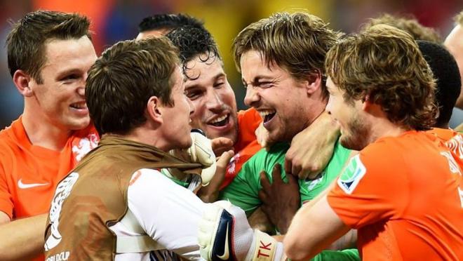Dutch players swarm backup keeper Tim Krul after his game-winning save