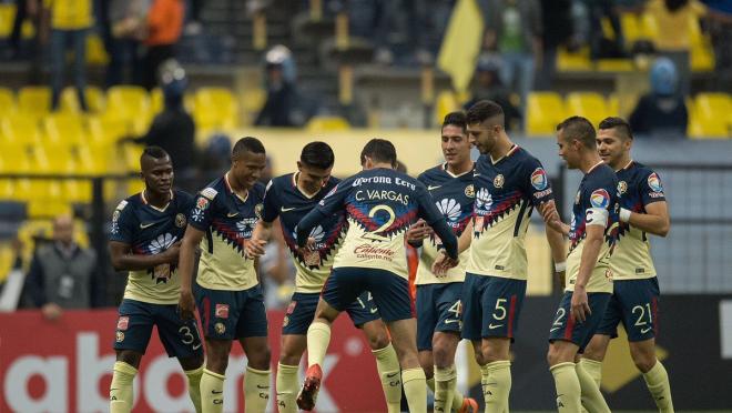 A happy Club America team huddles up after a goal