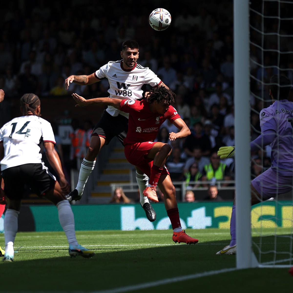 Aleksandar Mitrović jumps over Liverpool's Trent Alexander-Arnold to score Fulham's opening goal 